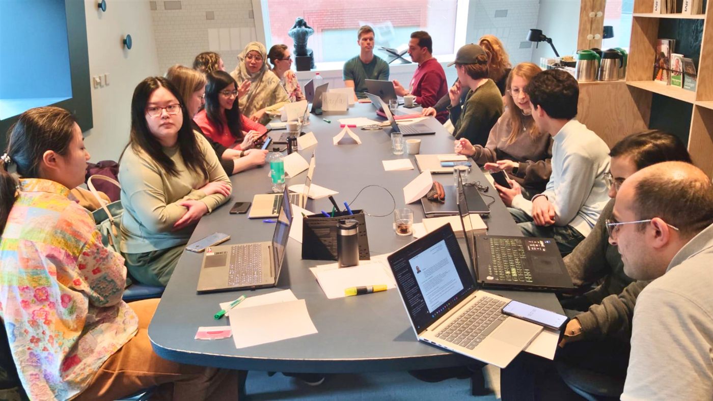 International participants gathered around a workshop table